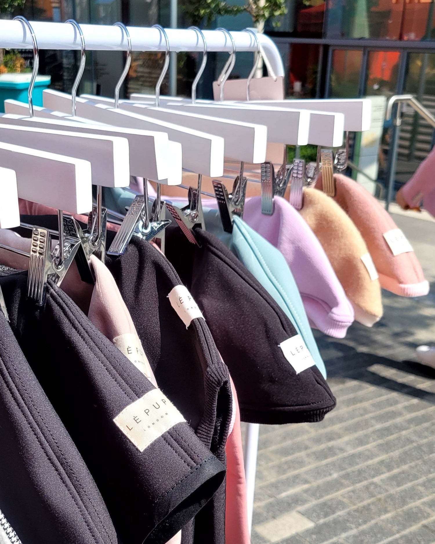 Custom made dog clothes for whippets and sighthounds hanging on a rail