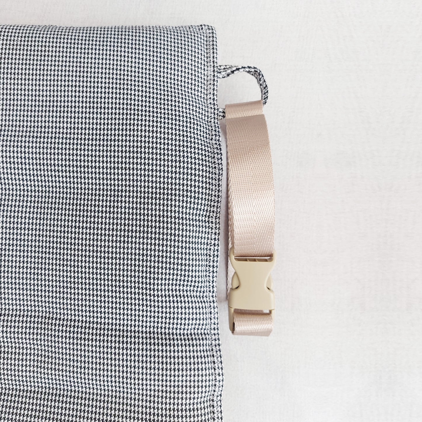 Quilted fleece and houndstooth fabric travel dog mat with detachable strap, perfect for comfort on the go by LE PUP.
