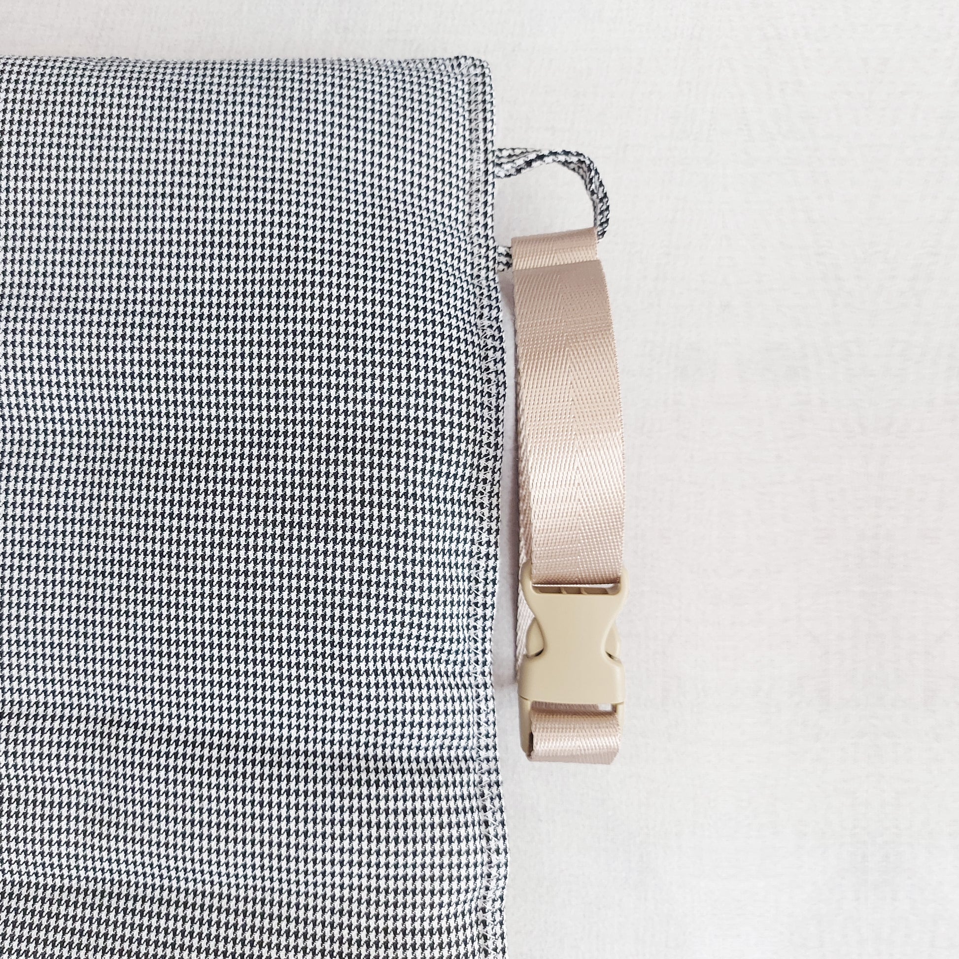 Quilted fleece and houndstooth fabric travel dog mat with detachable strap, perfect for comfort on the go by LE PUP.