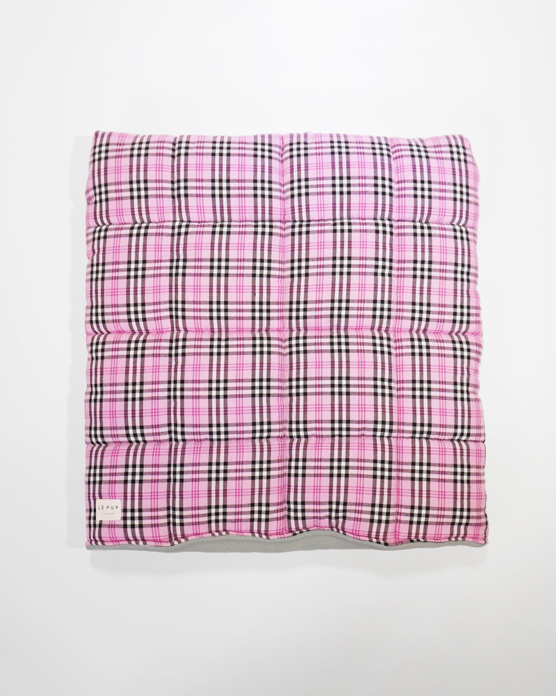 Top view of showing quilted snuggle sack in pink tartan for small breed by LE PUP.