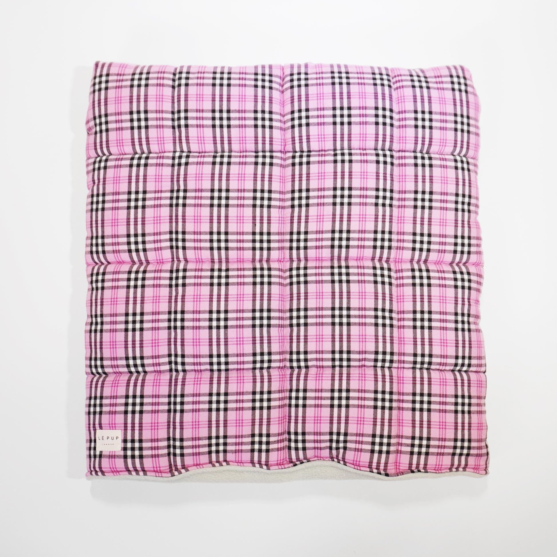 Top view of showing quilted snuggle sack in pink tartan for small breed by LE PUP.