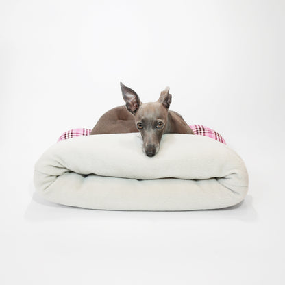 Italian greyhound resting on told of folded portable cosy and cushioned pet snuggle sack by LE PUP.